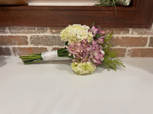 White and blush hydrangea bridal bouquet with a ribbon-wrapped stem